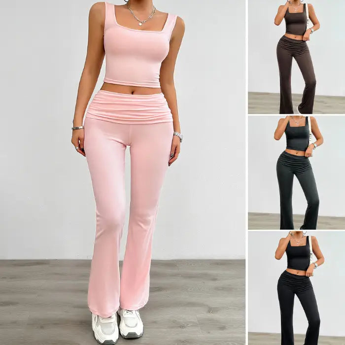 Women's pink yoga two-piece set with a sleeveless crop top and high-waisted flared pants, perfect for workouts.