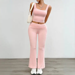 Stylish pink yoga two-piece set with a cropped tank top and high-waisted flared pants, ideal for yoga or casual wear.