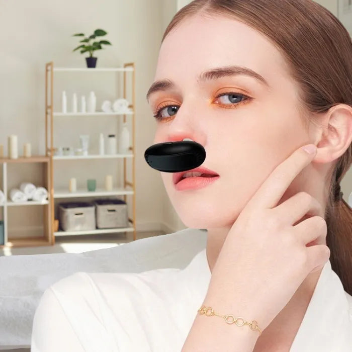 Young woman demonstrates use of red light nasal device in a minimalist home.