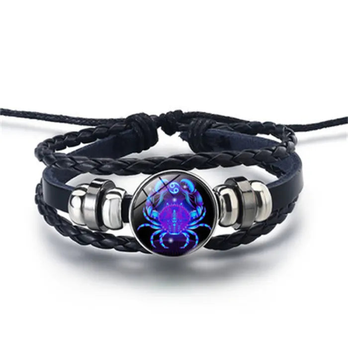 Zodiac Sign Bracelet featuring a luminous Cancer crab symbol in blue cosmic tones, paired with braided leather for a unique astrology jewelry piece.