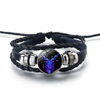 Zodiac Sign Bracelet featuring vibrant Capricorn symbol in glowing blue tones, paired with woven leather for a mystical cosmic jewelry look.