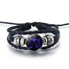 Zodiac Sign Bracelet featuring a radiant Libra scales symbol with deep blue detailing on a braided leather strap for celestial horoscope lovers.