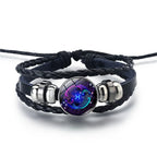Zodiac Sign Bracelet with glowing Pisces design in deep blue hues, presenting artistic astrology symbolism on a braided leather wristband.