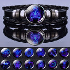 Zodiac Sign Bracelet featuring glowing Scorpio charm with additional zodiac inserts displayed below, highlighting celestial jewelry versatility.