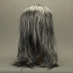 Zombie face mask back view emphasizing long gray hair and pale textured scalp.