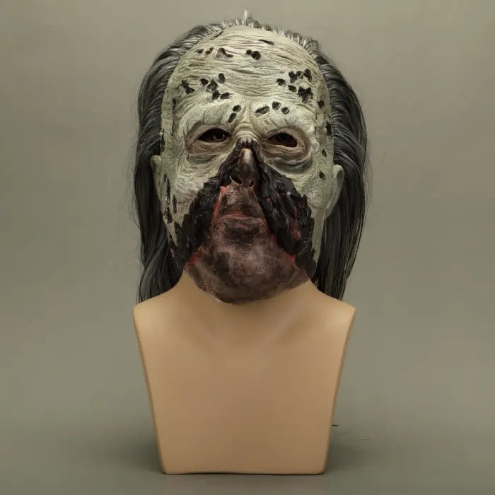 Horror-themed mask on a mannequin head against a plain background