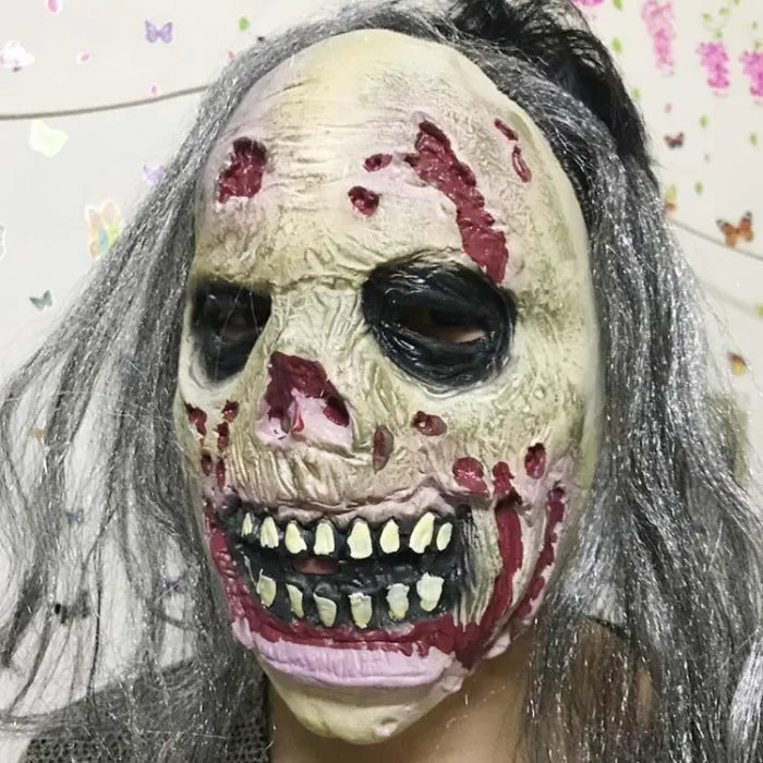 Gruesome zombie costume mask featuring exposed skull, dark eyes, and blood stains.
